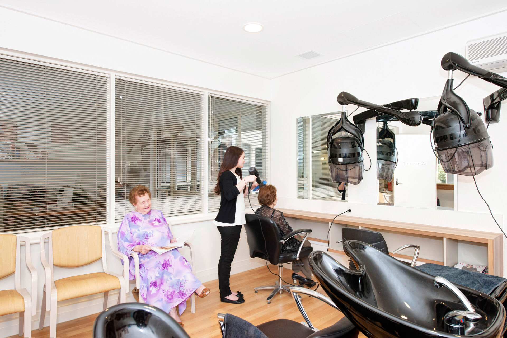 aged care resident getting her hair cut in the hairdressing salon at baptistcare warena centre in bangor sutherland shire nsw