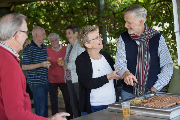 independent over 55s retirement living residents enjoying a bbq socialising during their retirement