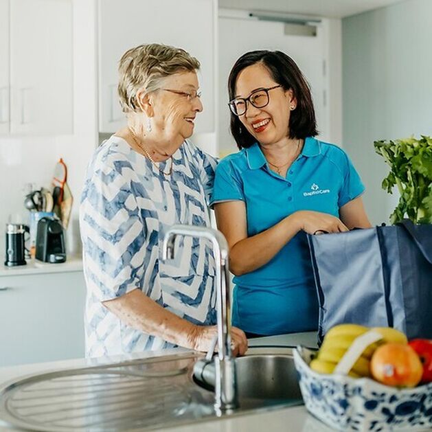 baptistcare in home care aged care worker employee cleaning dishes in a resident's home so they can live independently