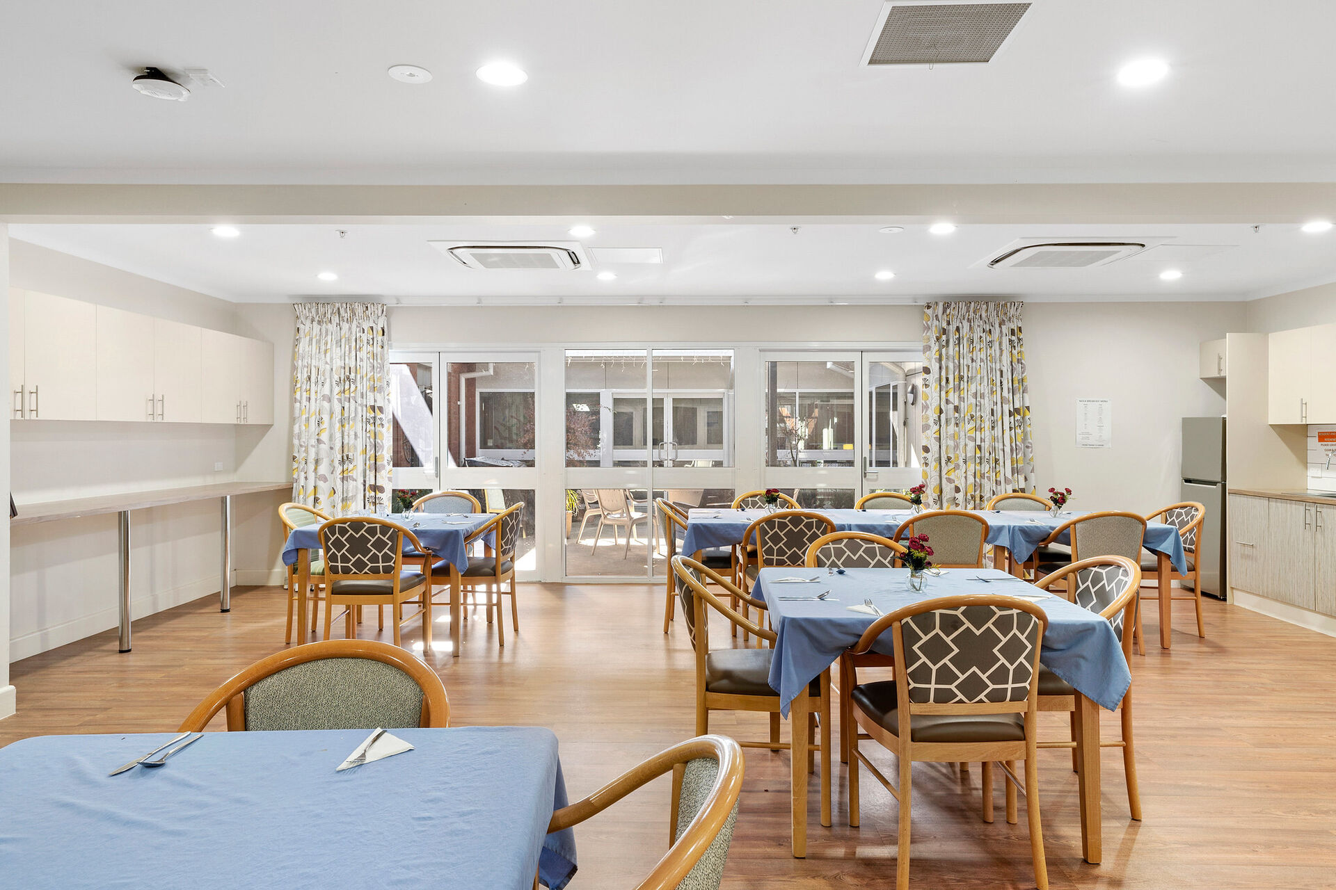modern communal dining room for nursing home residents to be served fresh meals at baptistcare niola centre aged care home in parkes nsw