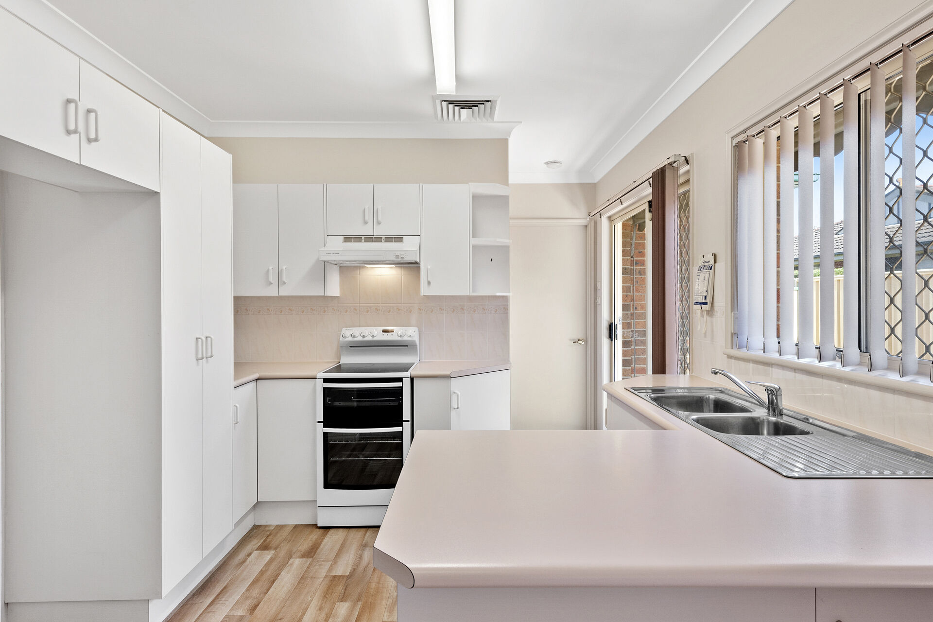 spacious kitchen with storage and natural light in the 2 bedroom home at the over 55s baptistcare All Saints retirement village in New Lambton Newcastle