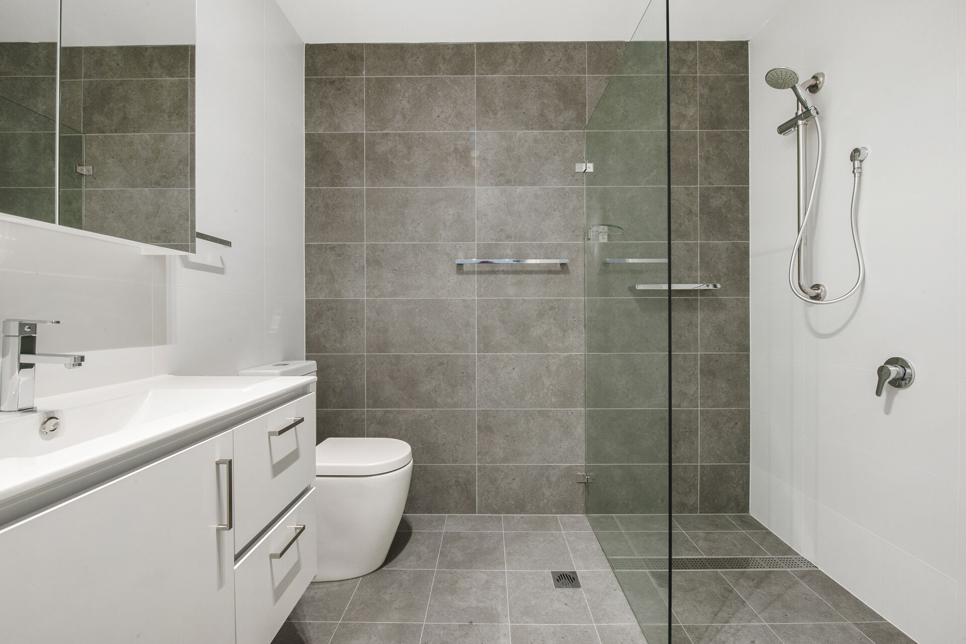 modern bathroom with floor to ceiling tiles of retirement village apartment baptistcare aminya village in baulkham hills enabling over 55s to downsize
