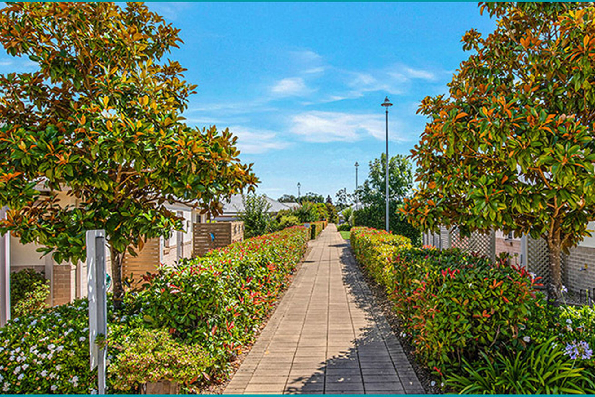 outdoor walking path lined with beautifully maintained gardens at baptistcare durham green retirement village in menangle nsw