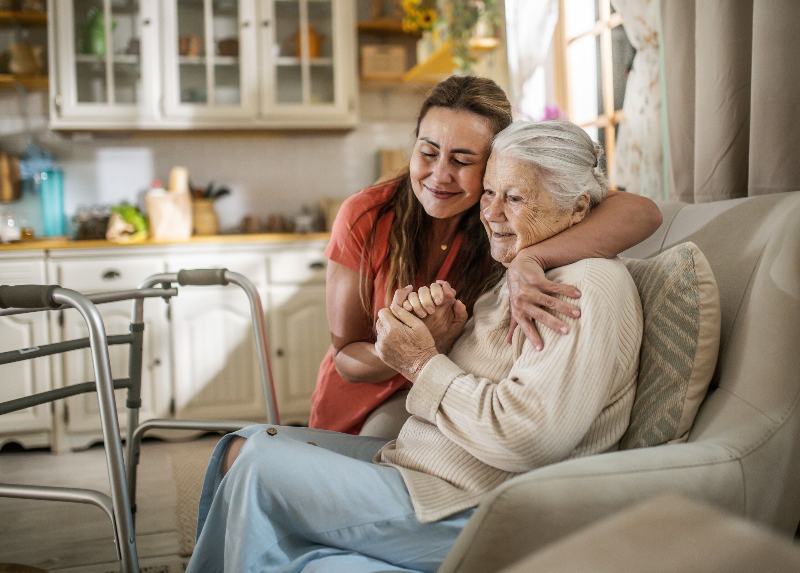baptistcare aged care workers and chaplain with a nursing home resident with a myteam sign