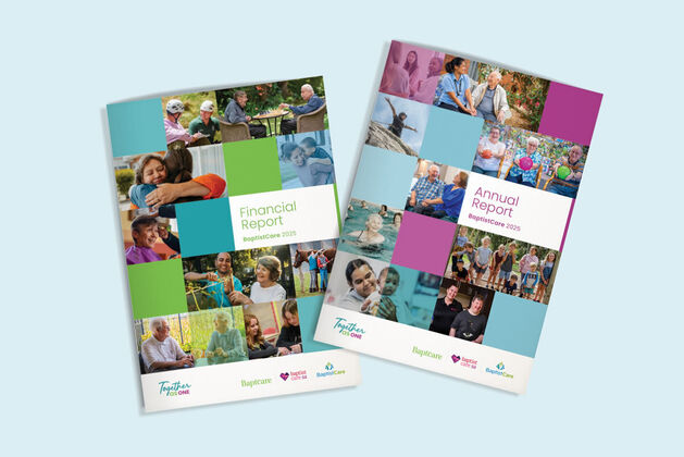 Man with arm around teenage boy who is holding a basketball