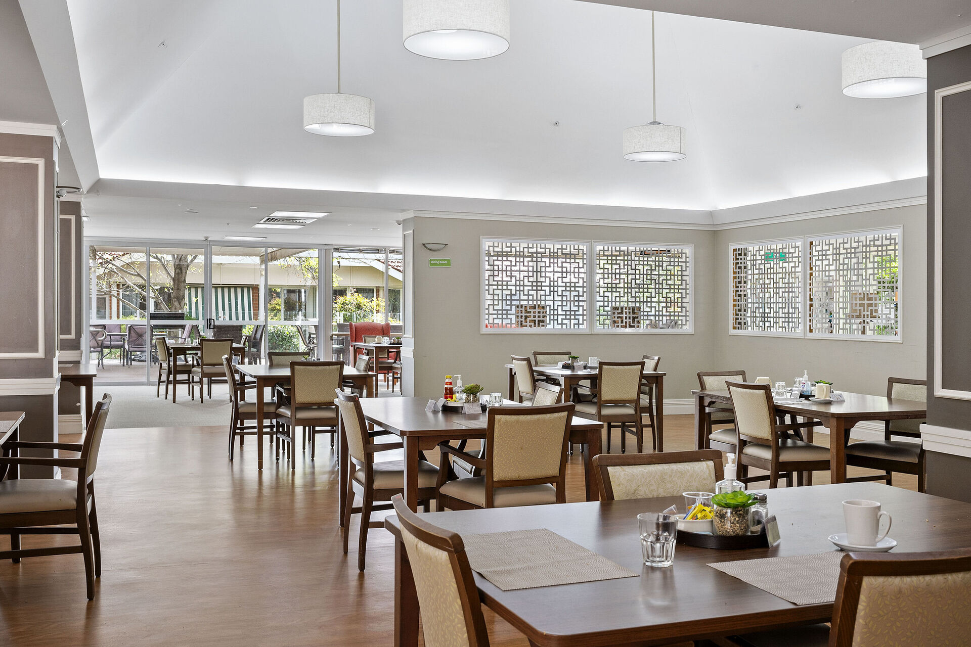 dining room for aged care residents with natural light at baptistcare carey gardens residential aged care home