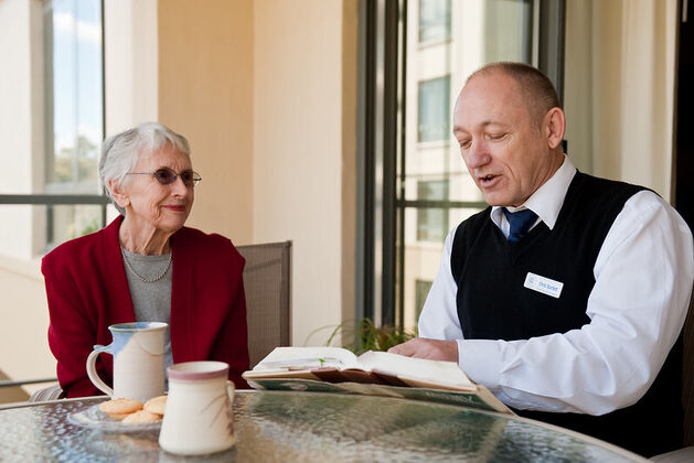 baptistcare chaplain sitting with an aged care home resident in the nursing home