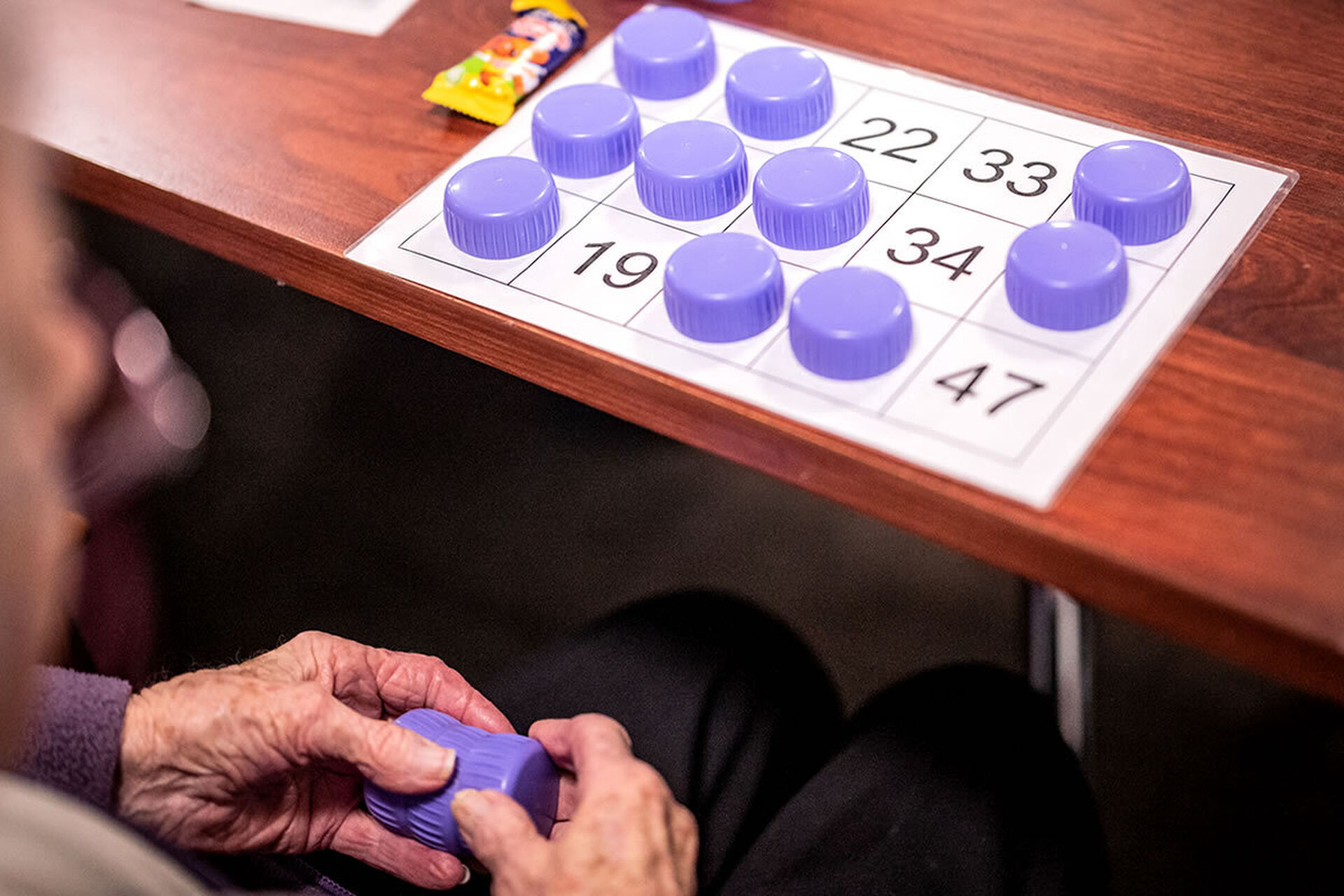a nursing home group of residents playing bingo at baptistcare morrison gardens aged care home in midland wa