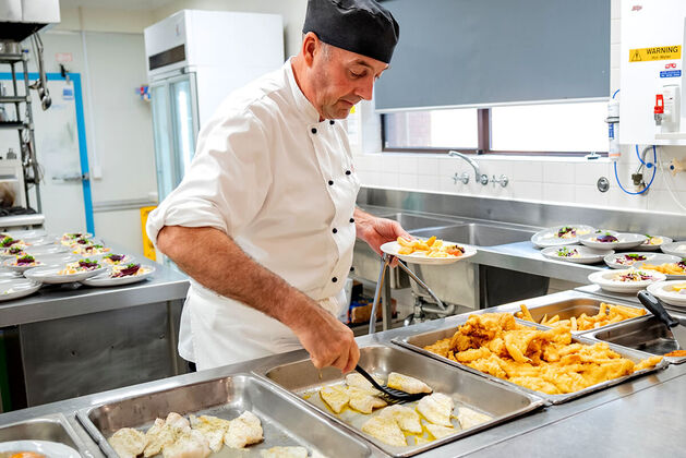 a chef cooking delicious and nutritious meals at one of our baptistcare aged care homes in wa