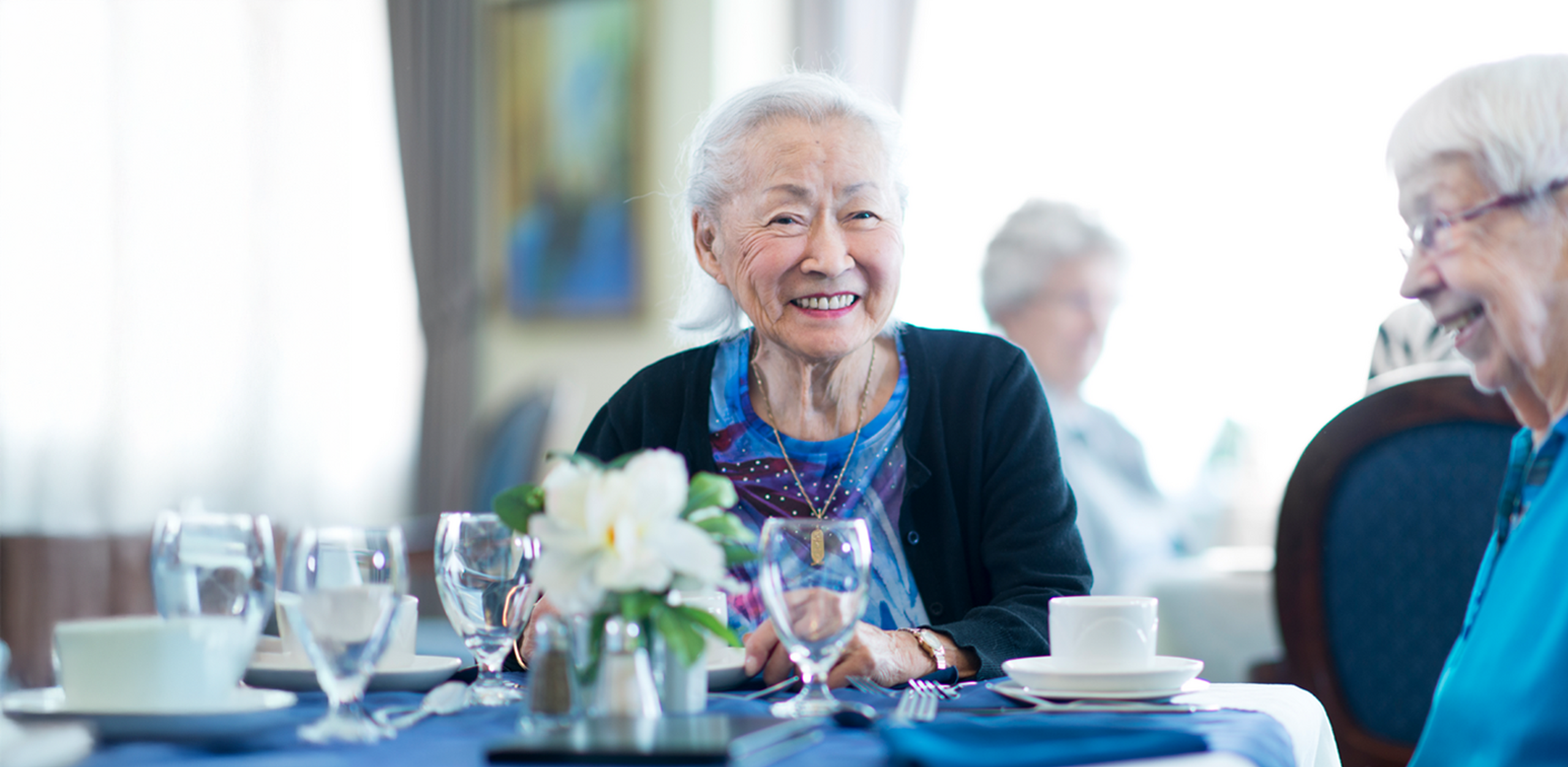 aged care resident enjoying time with friend in nursing home