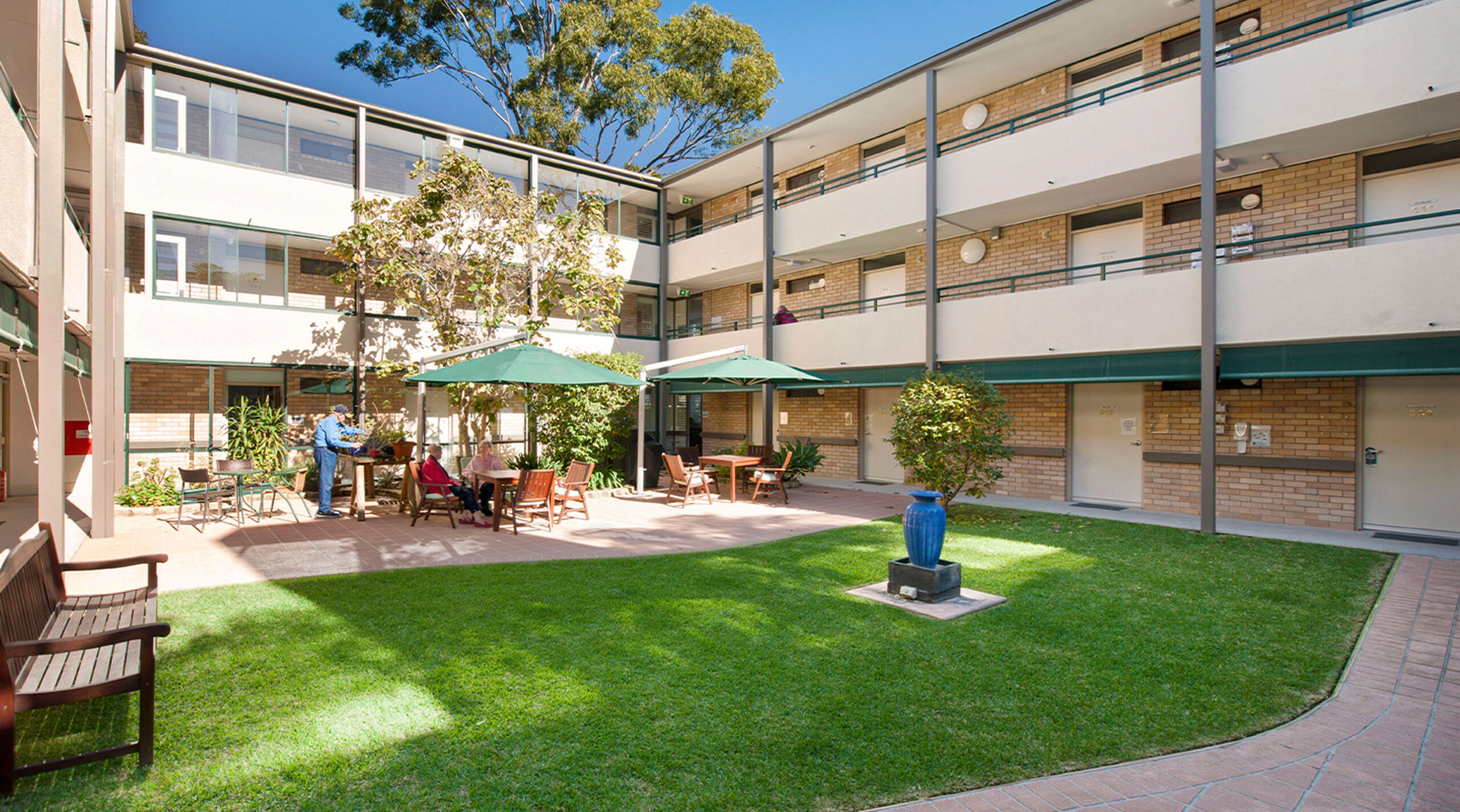 grassed aged care home courtyard to the three story baptistcare cooinda court residential aged care home in macquarie park