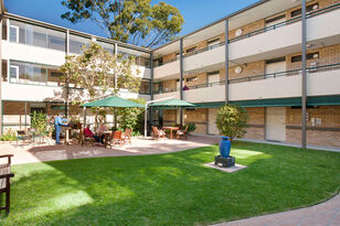 grassed aged care home courtyard to the three story baptistcare cooinda court residential aged care home in macquarie park nsw northern sydney