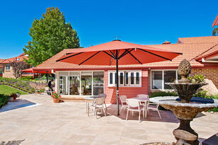 large and spacious outdoor sitting area for aged care residents with shade from large umbrellas at baptistcare morven gardens in leura nsw blue mountains