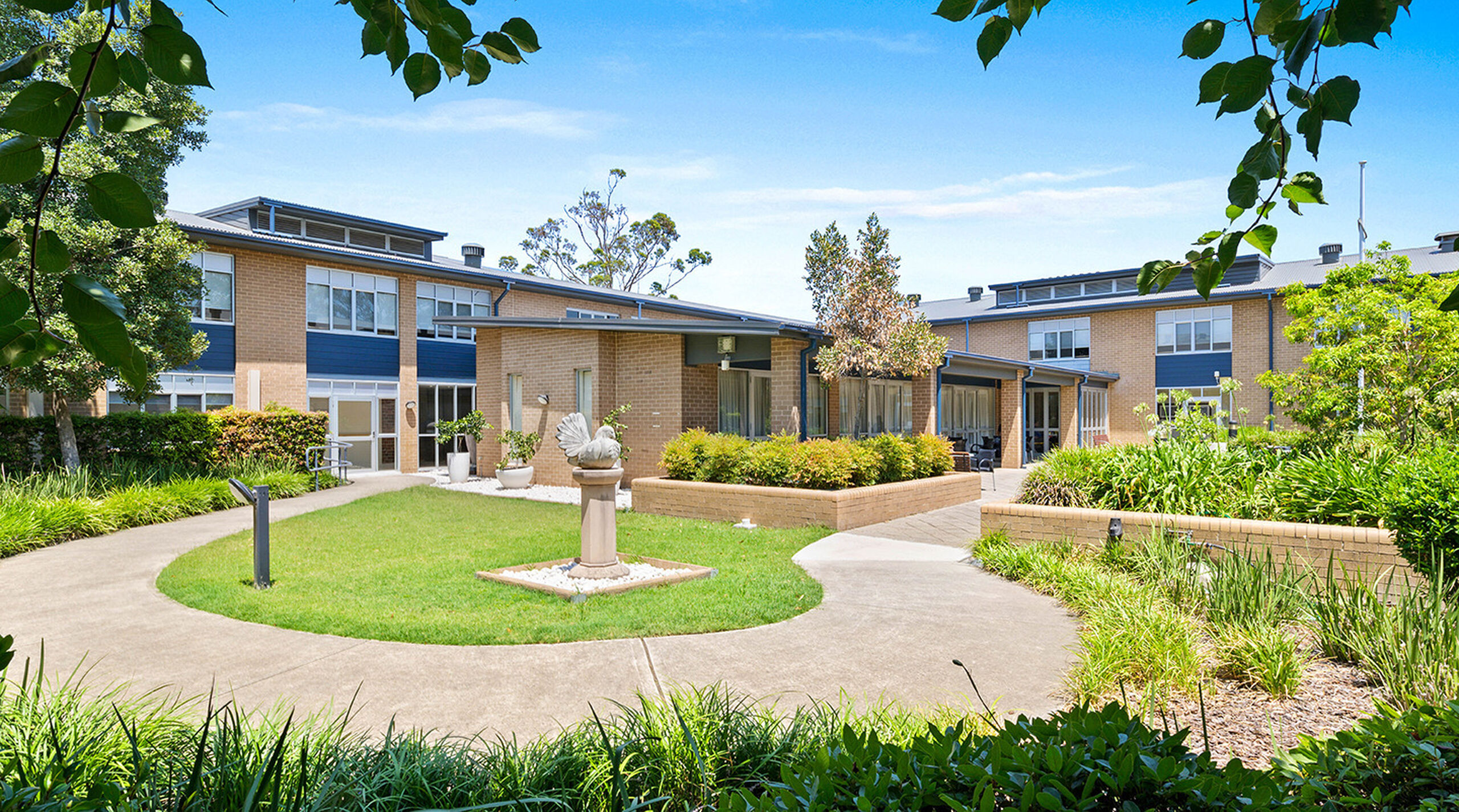 beautiful large gardens at the entrance of baptistcare shalom centre modern aged care home providing low level care and dementia care for aged care residents in macquarie park nsw