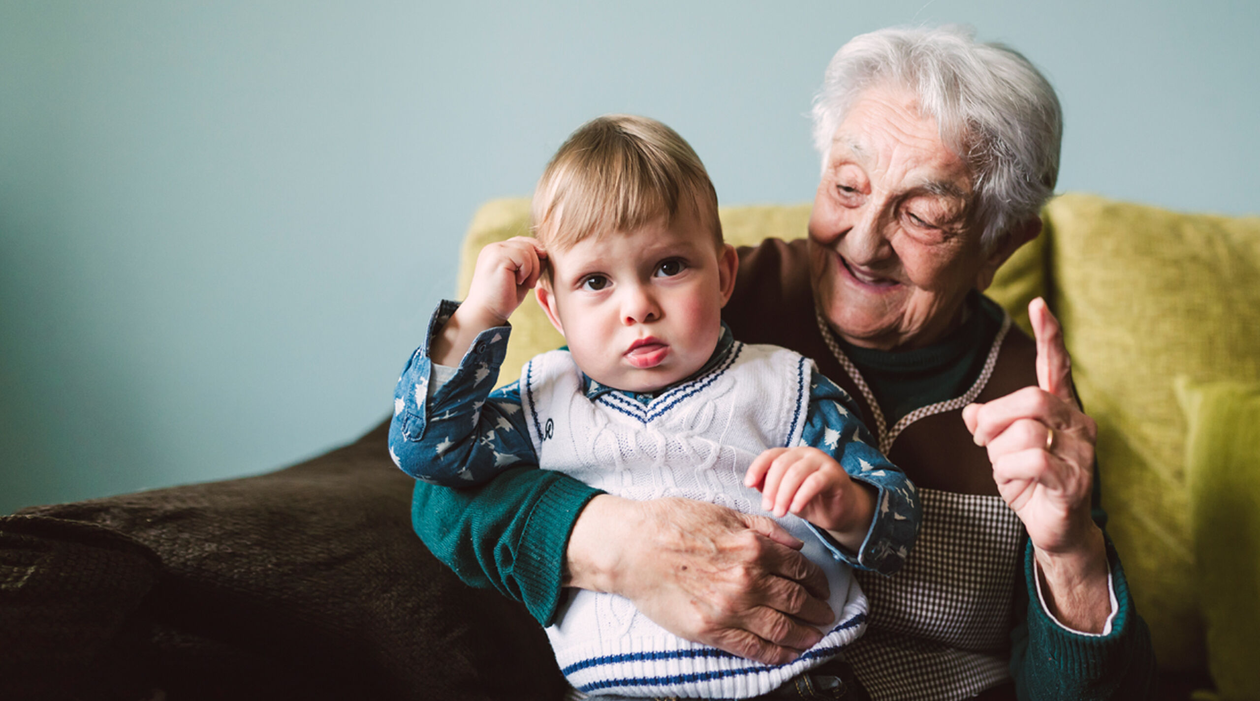 aged care resident enjoying time with grandson in nursing home