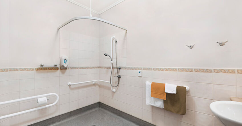 large ensuite bathroom for elderly aged care resident in baptistcare caloola centre residential aged care home