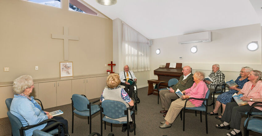 elderly aged care residents enjoying games and socialising in communal lounge room in baptistcare dorothy henderson lodge macquarie park nsw northern sydney residential aged care home