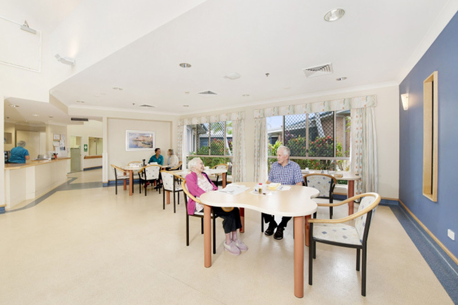 two aged care residents in the spacious dining room and sitting room at baptistcare maranoa centre aged care home in alstonville nsw far north coast