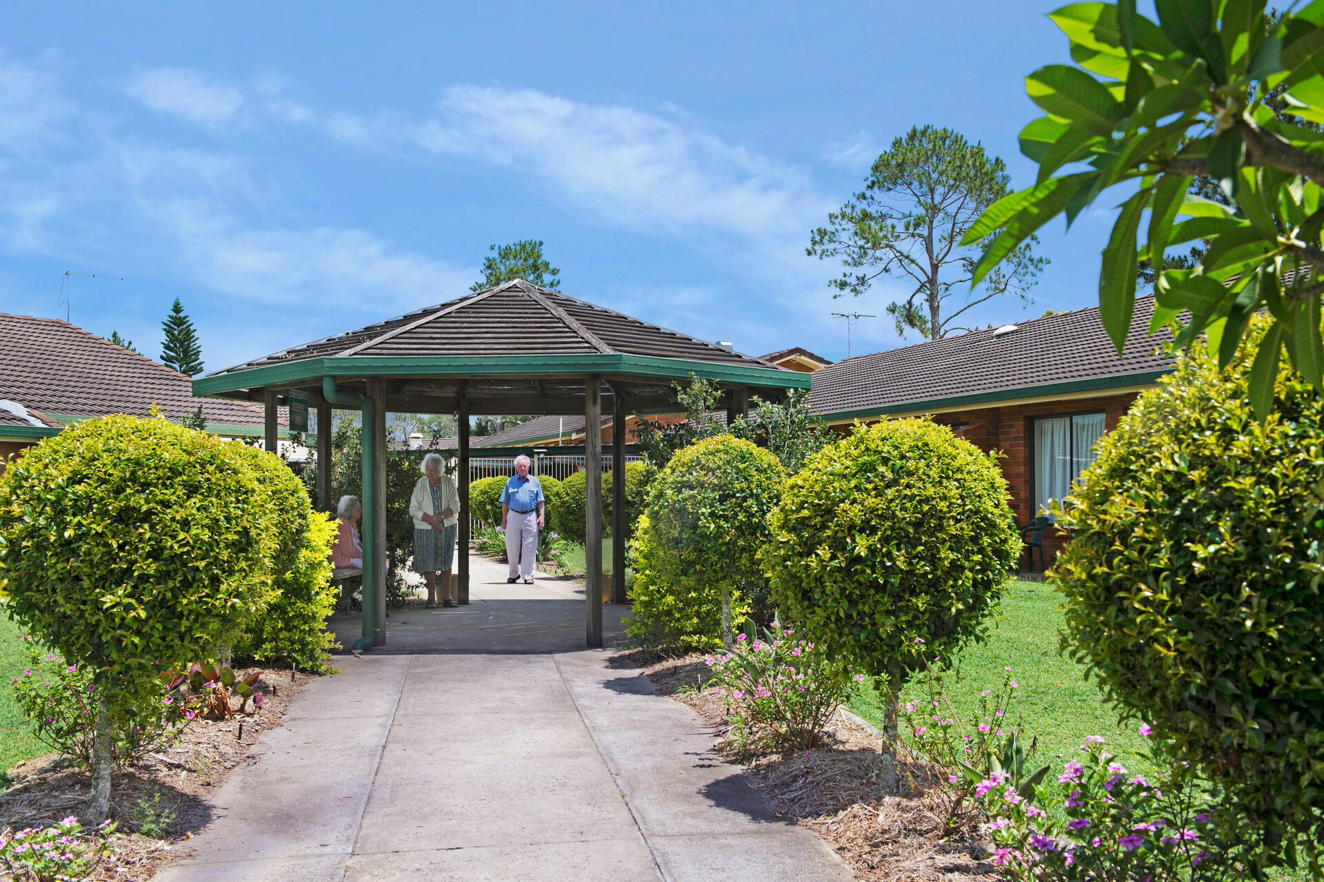 beautiful outdoor gardens with aged care residents sitting under a gazebo at baptistcare mid richmond centre residential aged care facility in coraki nsw far north coast