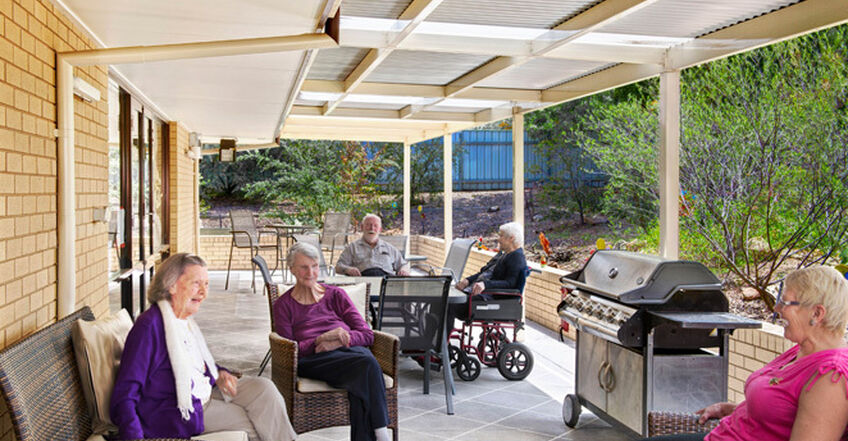 large communal verandah for elderly aged care residents to enjoy sitting and socialising outside in the sun at baptistcare caloola centre residential aged care home