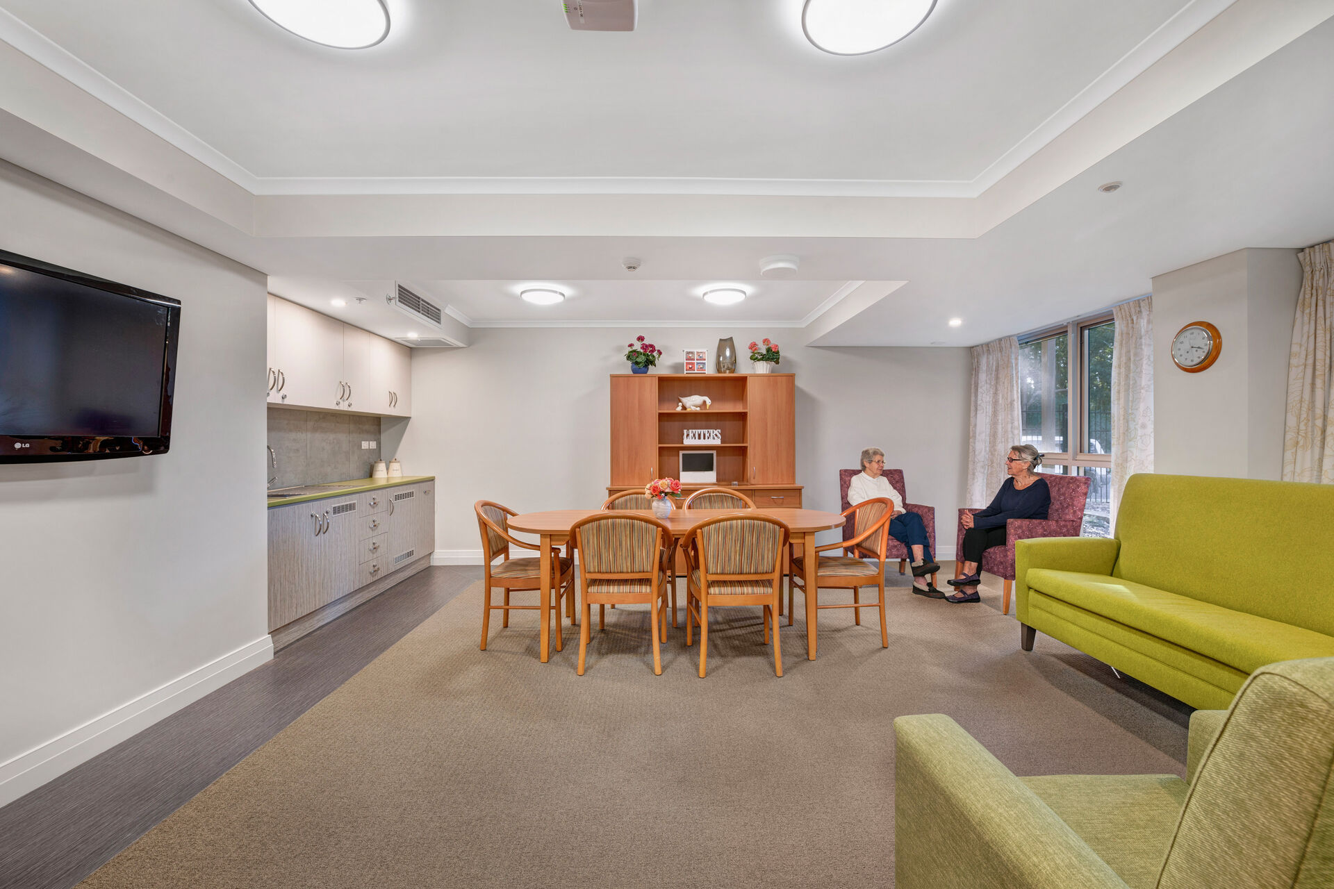 spacious lounge room with couches for aged care residents to socialise at baptistcare orana centre aged care home in point clare nsw central coast