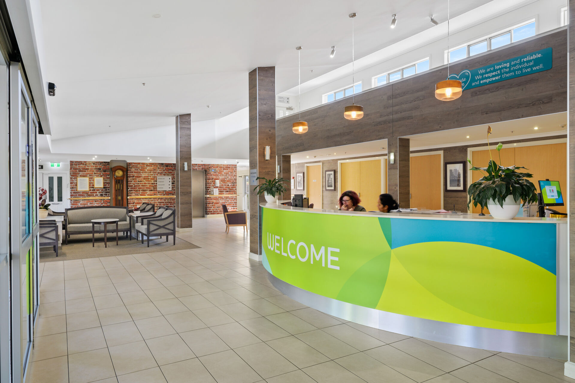 reception and entrance with aged care workers in the modern foyer of baptistcare shalom centre aged care home in macquarie park nsw