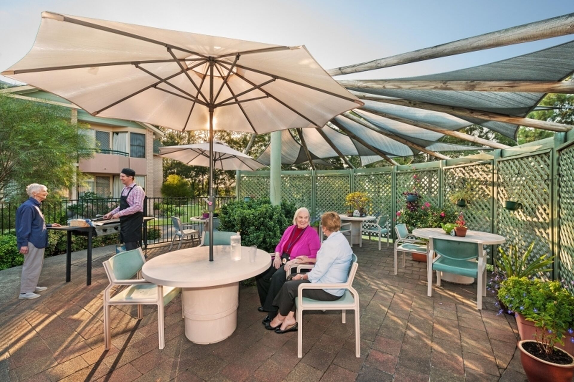 outdoor sitting area shaded with a large white umbrella for aged care residents of baptistcare warabrook centre aged care home in warabrook newcastle nsw