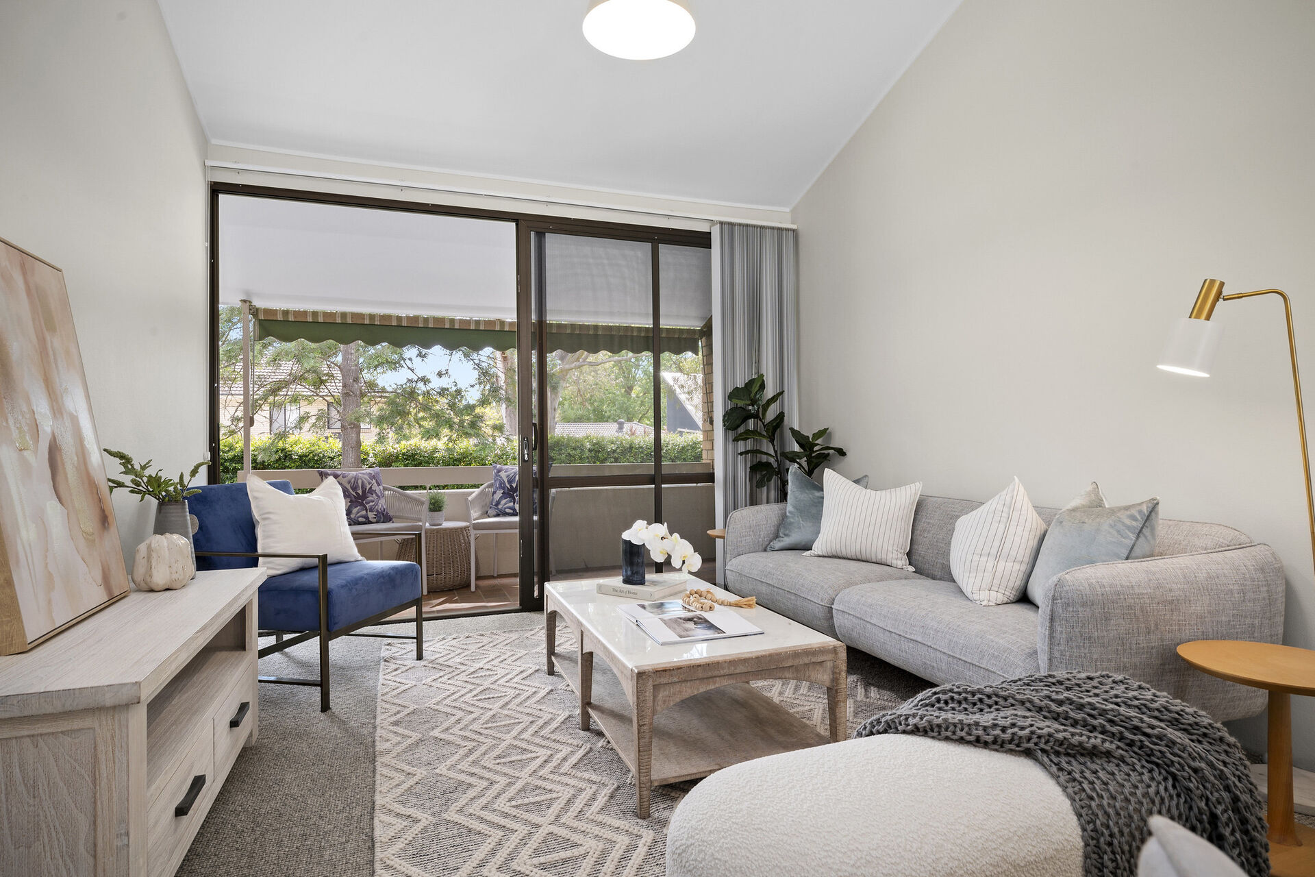 modern furnished lounge room with natural light from large window of retirement village apartment baptistcare aminya village in baulkham hills enabling over 55s to downsize