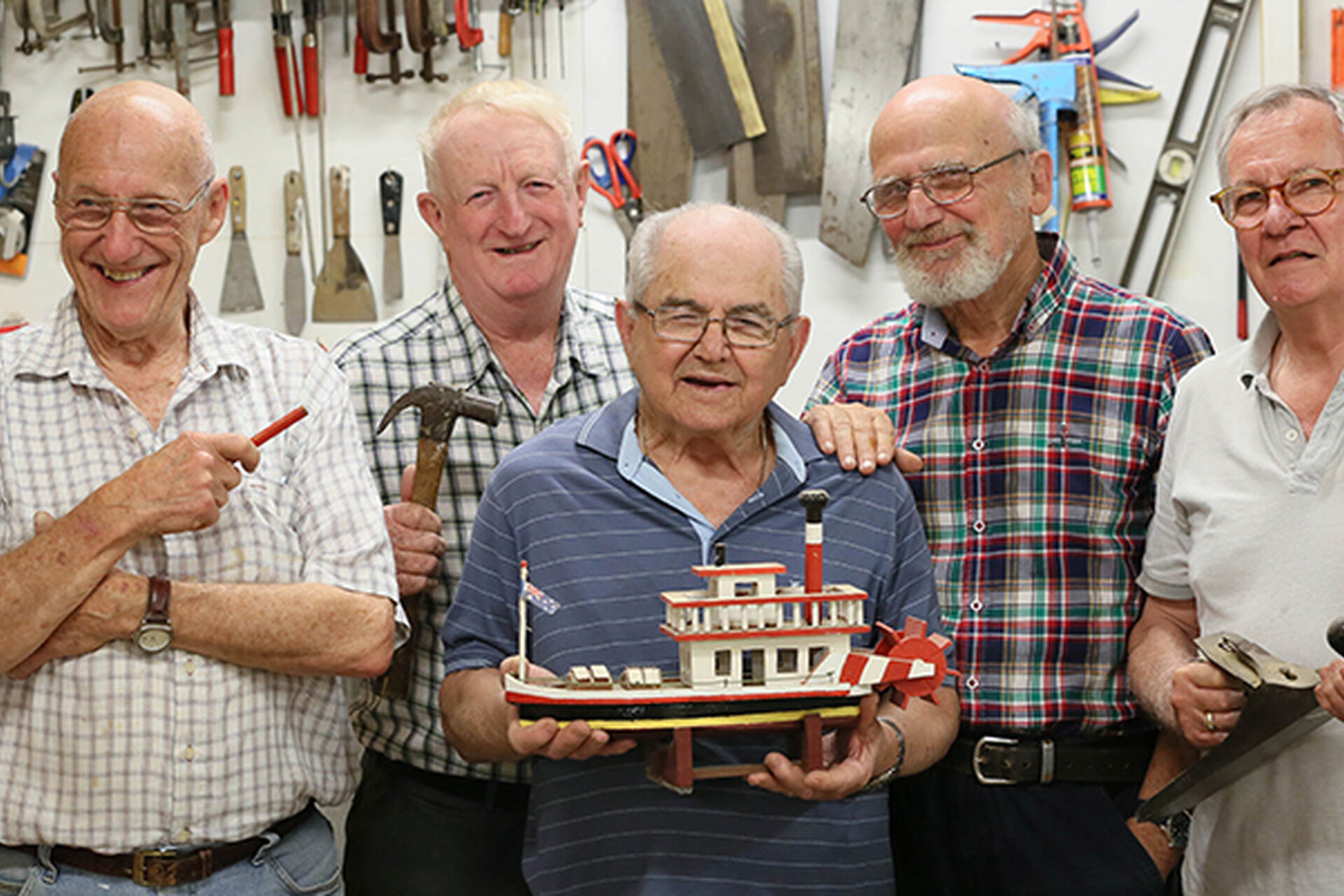 male residents in mens shed with wooden toys at baptistcare gracewood retirement village in kellyville hills district