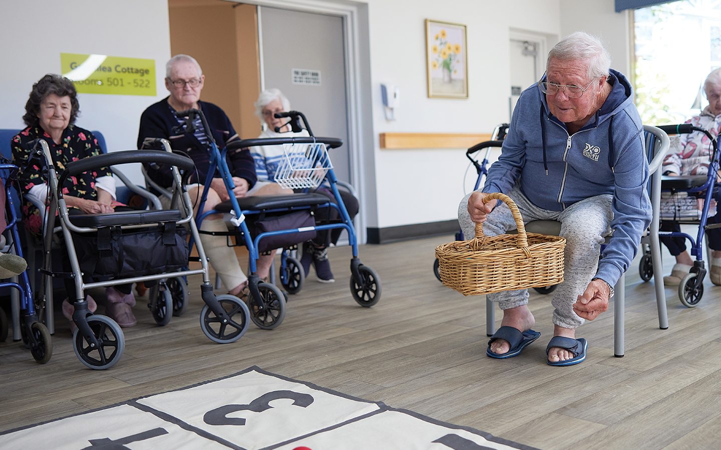 Residents at a BaptistCare residential aged care home enjoy a game of carpet bowls.